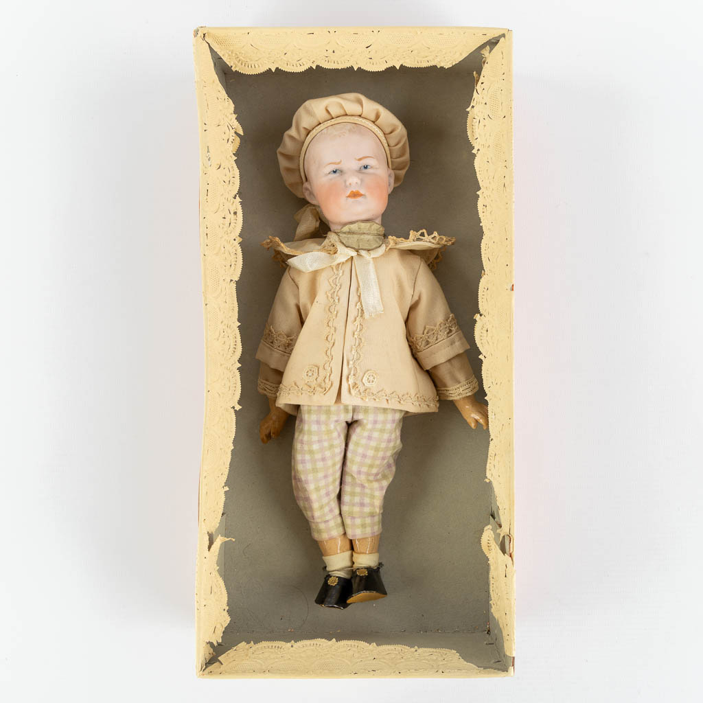 Heubach, Germany, a bisque doll in the original box. (L:7,5 x W:16,5 x H:33,5 cm)