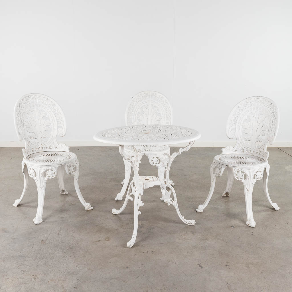 A garden set, consisting of a table and 3 chairs, white patinated aluminium. (H: 65 x D: 70 cm)