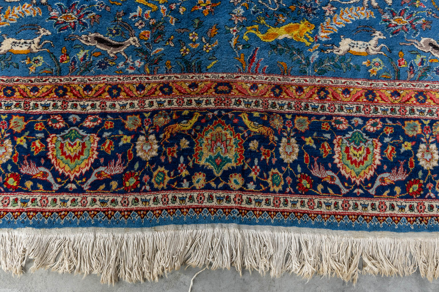 An Oriental hand-made carpet with figurative decor, Tabriz. (L:340 x W:243 cm)