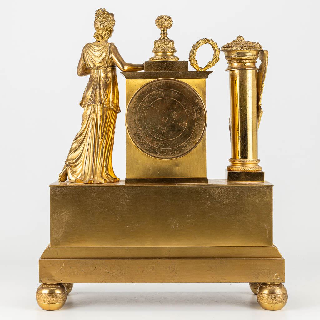 A mantle clock made of gilt bronze in empire style. The first half of the 19th century. (H:42cm)