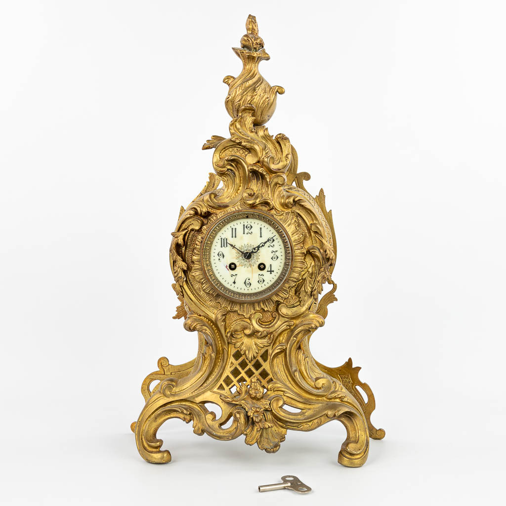 A table clock made of bronze in Louis XV style. (H:60cm)