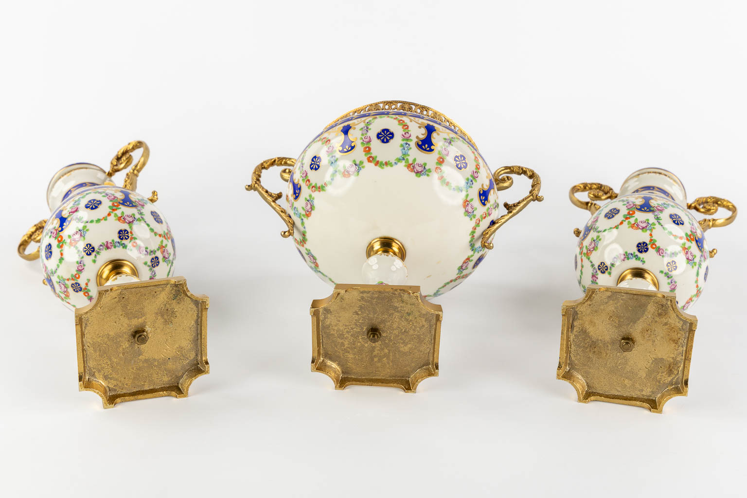 A.C.F. a three-piece mantle garniture, glazed ceramics mounted with bronze. (H:41 cm)