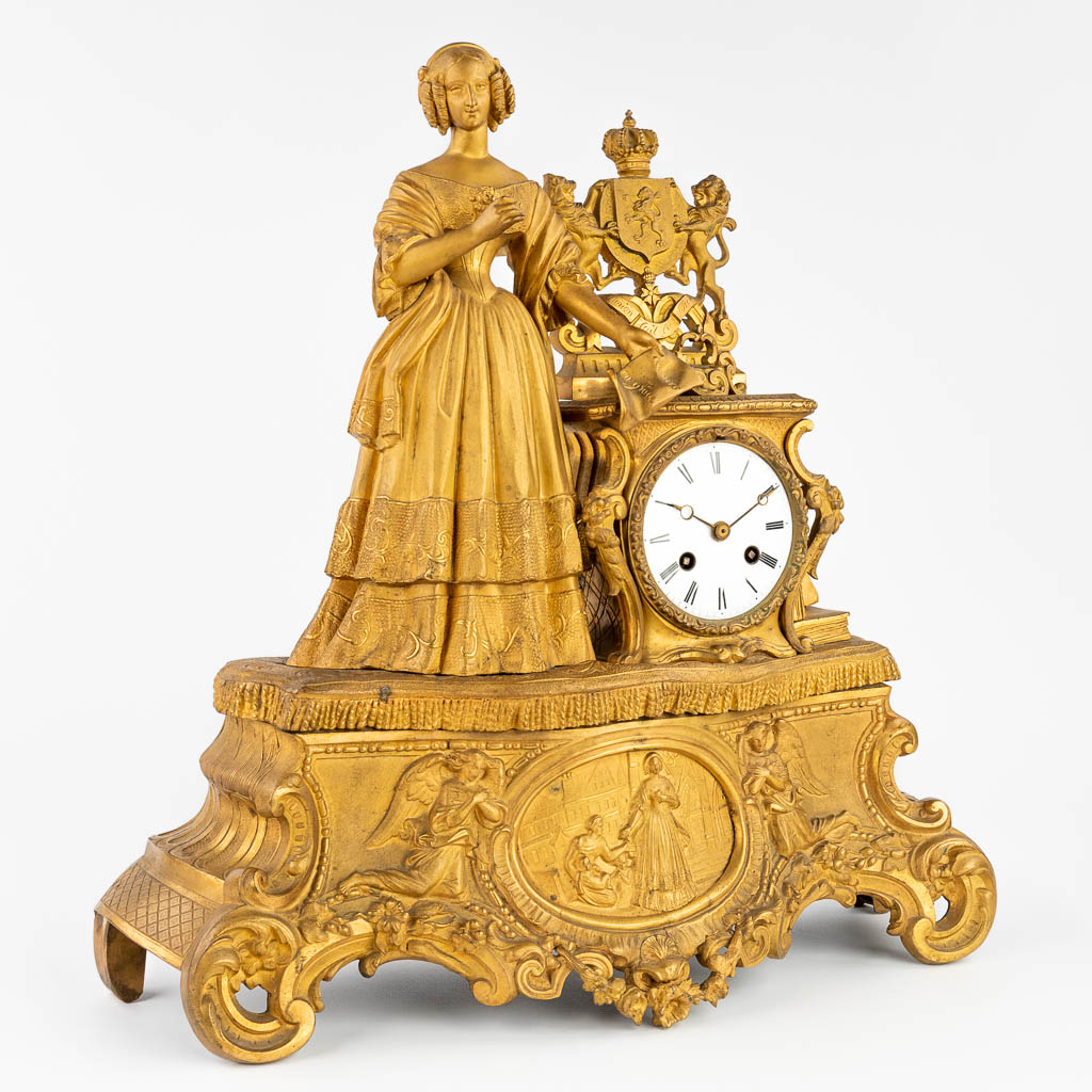 An antique mantle clock made of gilt spelter. 19th C. (44 x 45cm)