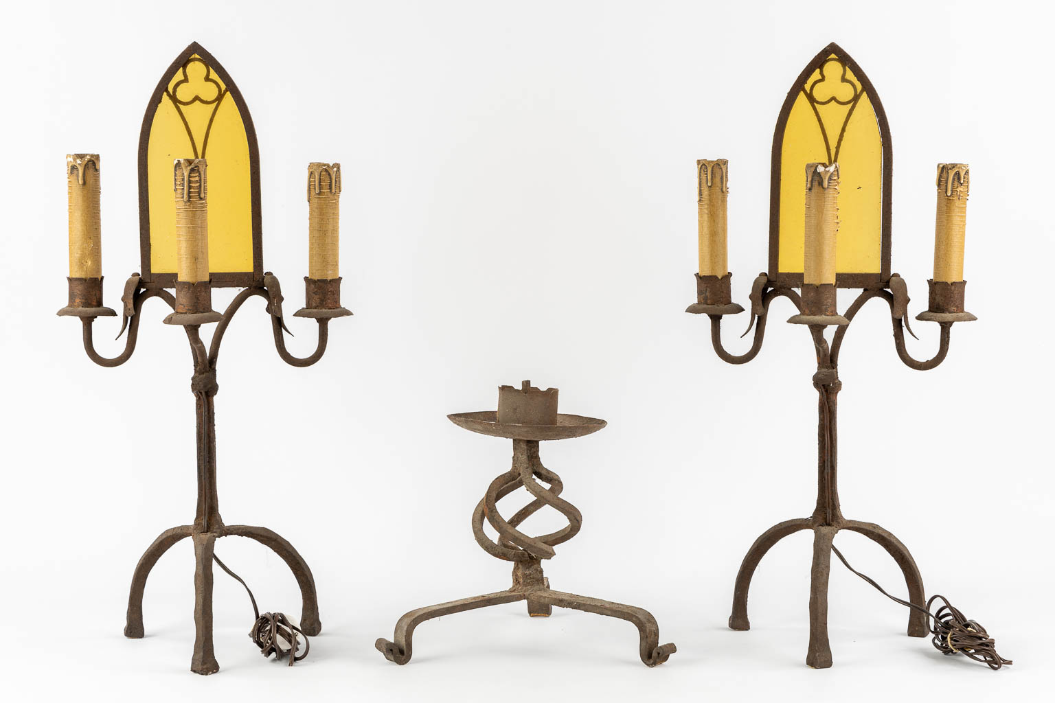 A pair of wrought iron table lamps in a Gothic Revival style. Added a candlestick. (H:63 cm)