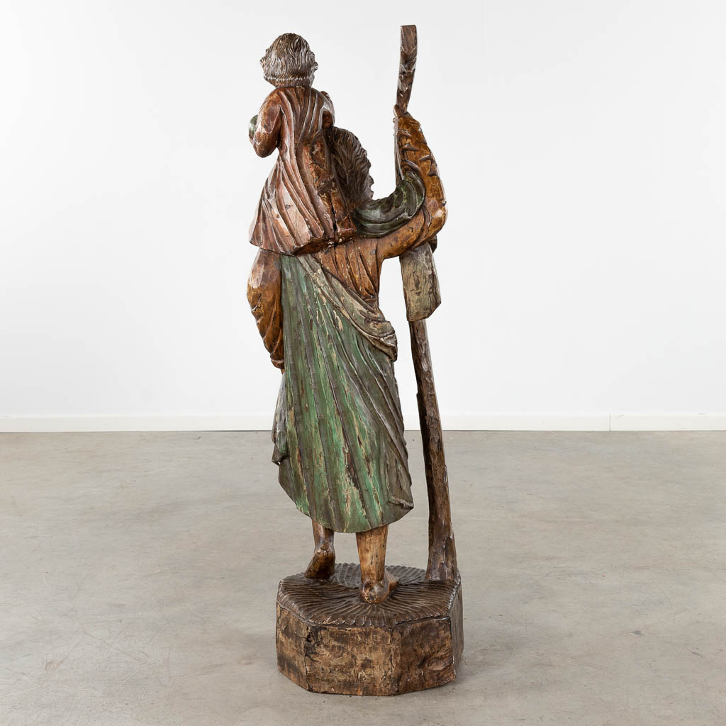 A large wood-sculptured figurine of Saint Christopher. Circa 1900. (D:35 x W:40 x H:127 cm)