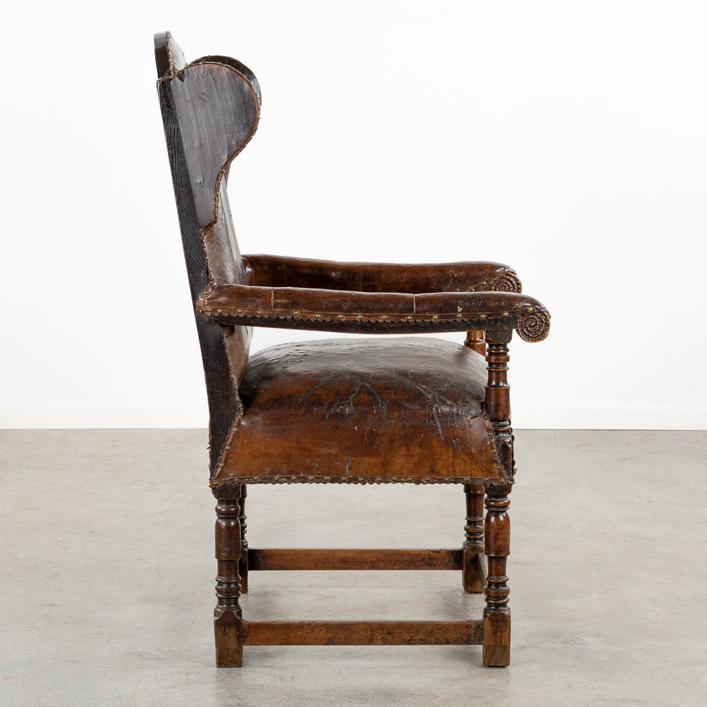 An antique Throne chair, leather on wood, great patina. 18th C. (L:76 x W:67 x H:125 cm)