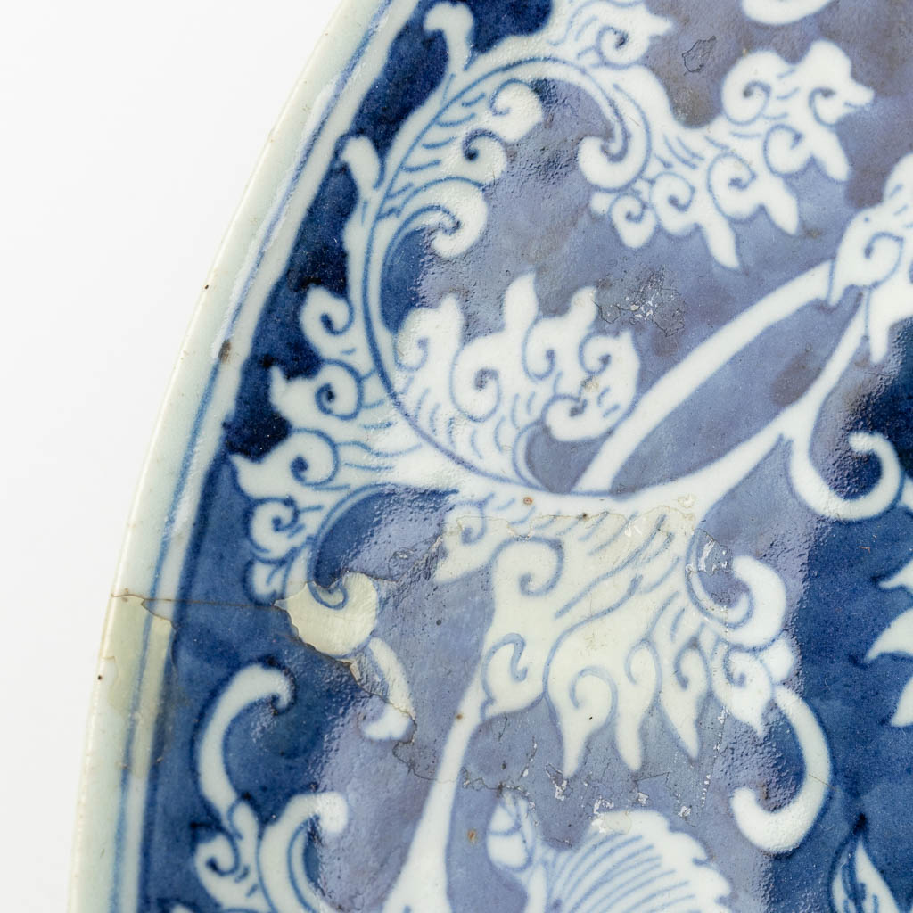 A large Chinese plate with blue-white floral decor. 