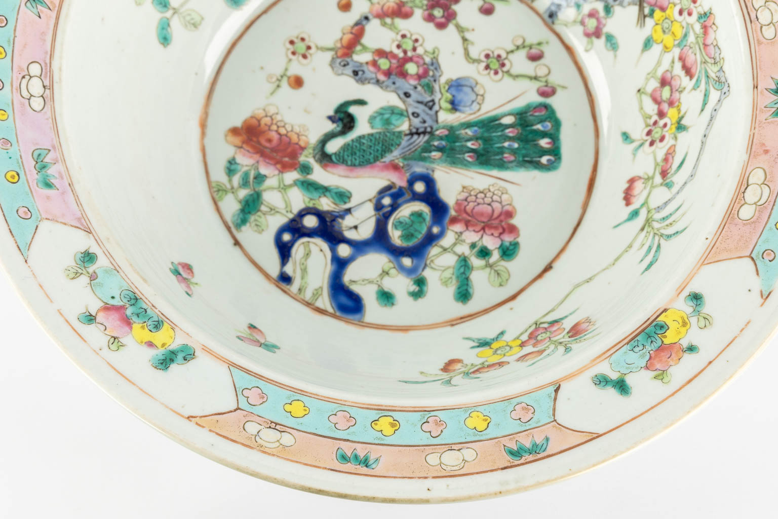 A large Chinese bowl, Famille Rose decorated with a Peacock and blossoms. 19th century. (H:12,5 x D:37 cm)