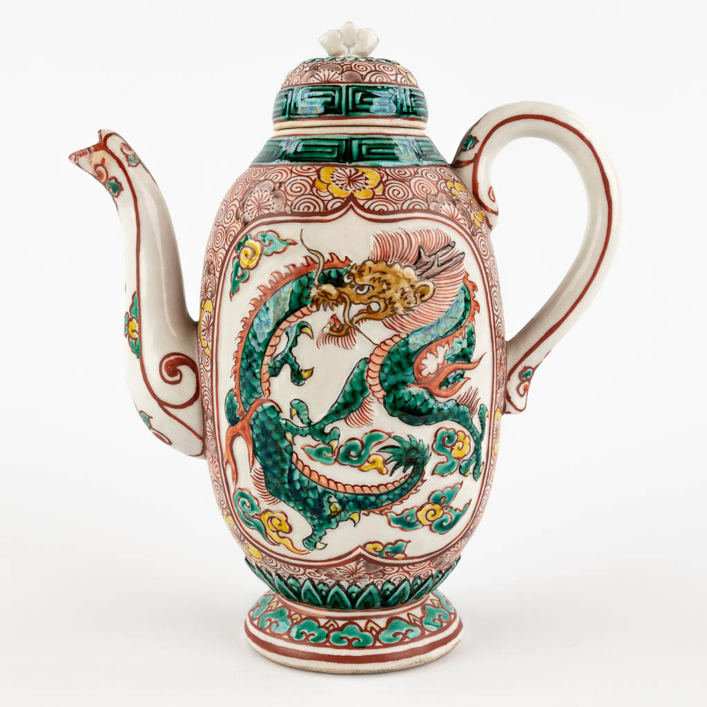 A teapot with a Famille Verte relief decor, probably Chinese export for the middle eastern market. 19th/20th C. (W:15 x H:18 cm)