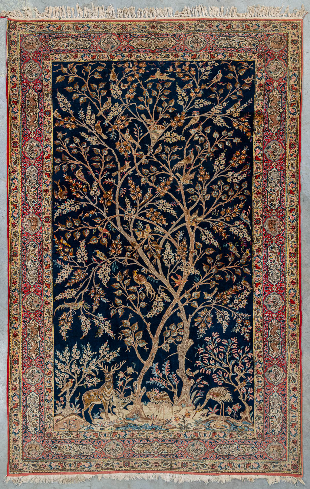 An antique hand-made carpet 'Ghom', made in Iran. 324cm x 207cm. (207 x 324 cm)
