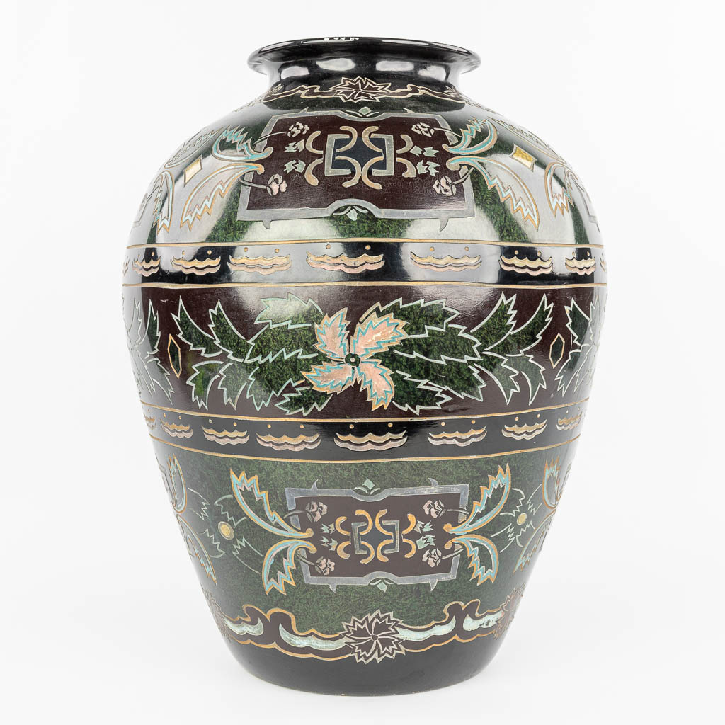 A decorative vase made of glazed porcelain with relief decor. (H:52cm)
