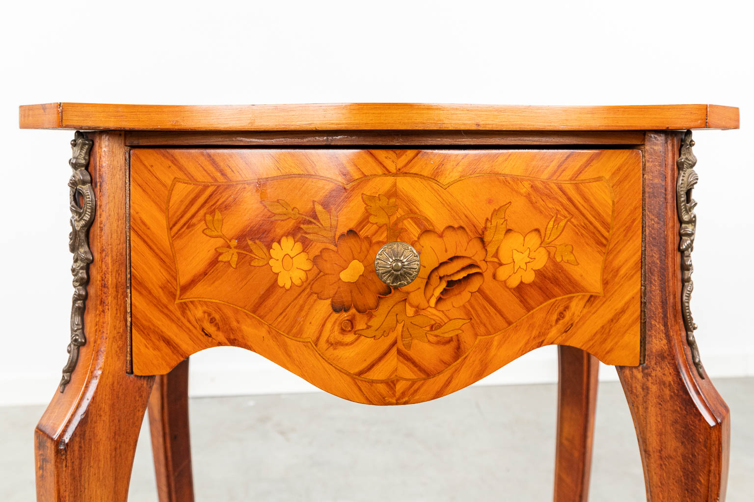 A side table finished with marquetry inlay and mounted with bronze. (H:69cm)