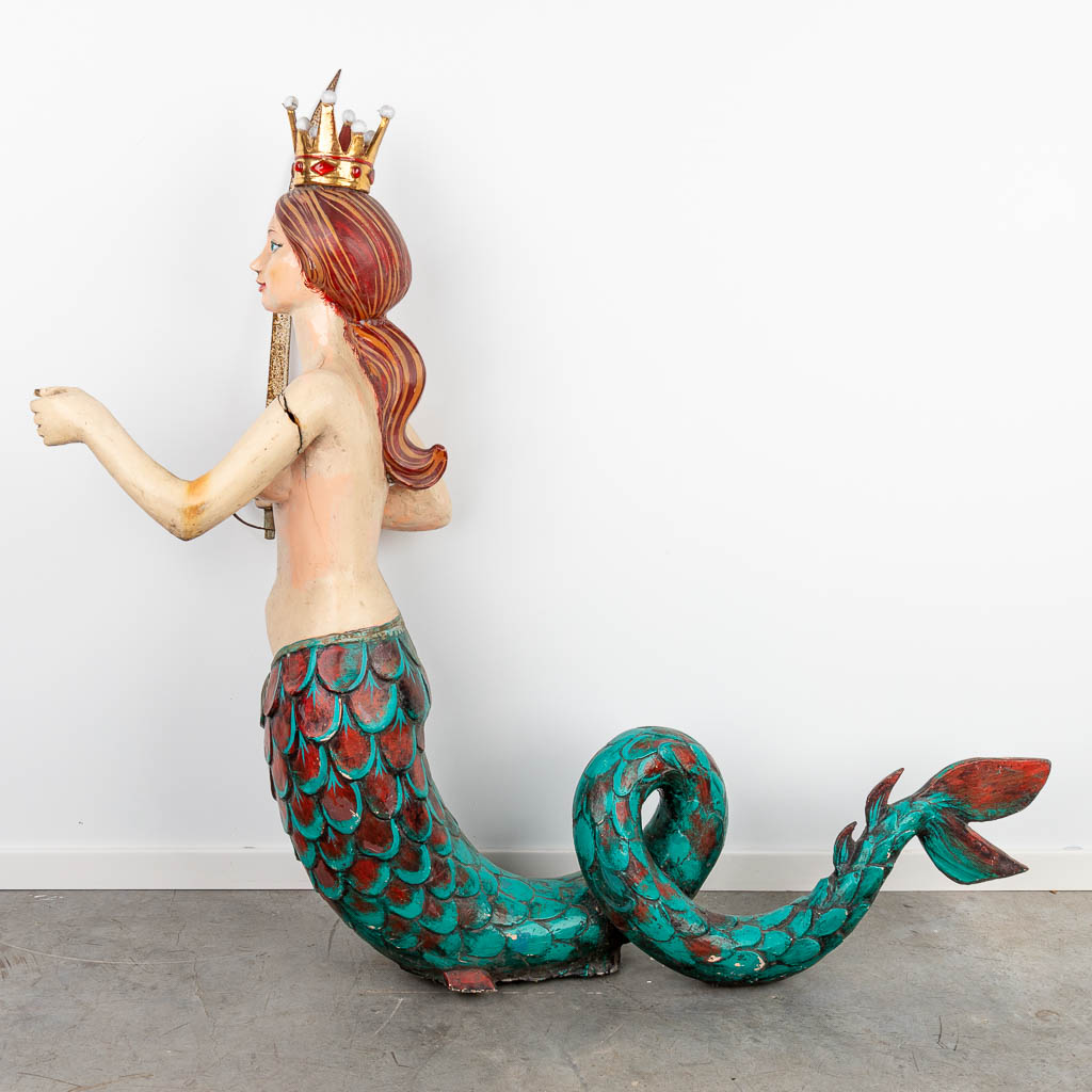 A large figurine of a mermaid, probably coming from a caroussel. (H:150cm)