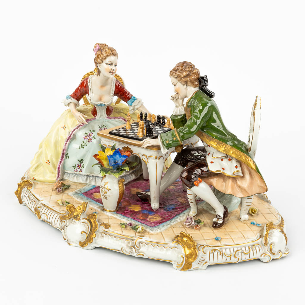 A large porcelain group of a chess-playing couple marked O. Enders and Volkstedt-Rudolstadt. (H:23cm)