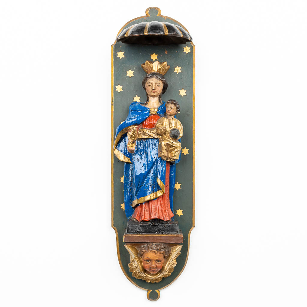 A statue of Madonna with child mounted in a young stand. (H:62,5cm)