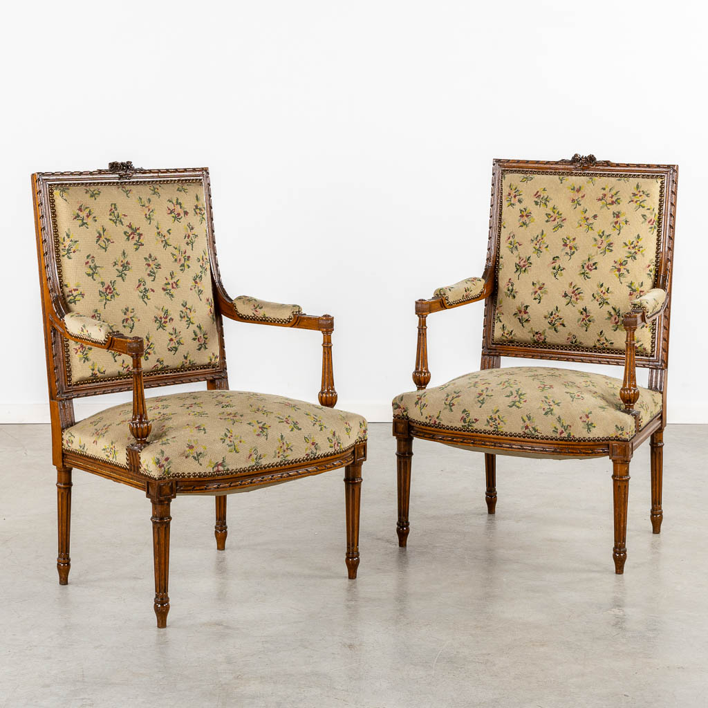 A pair of wood-sculptured armchairs with emboidered upholstry. Louis XVI style. (L:62 x W:64 x H:100 cm)