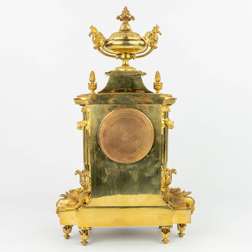 A mantle clock made of gilt bronze and marked Luppens. (H:48cm)