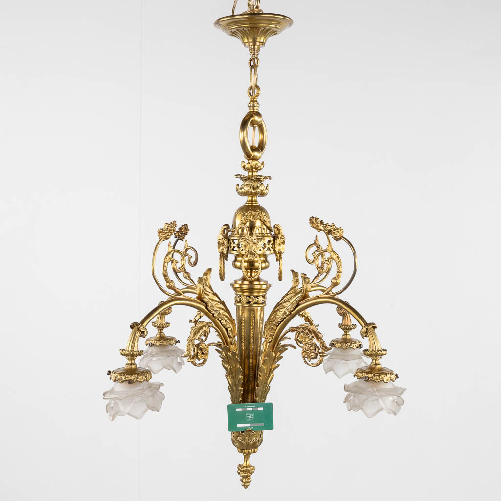 A chandelier, bronze finished with ram