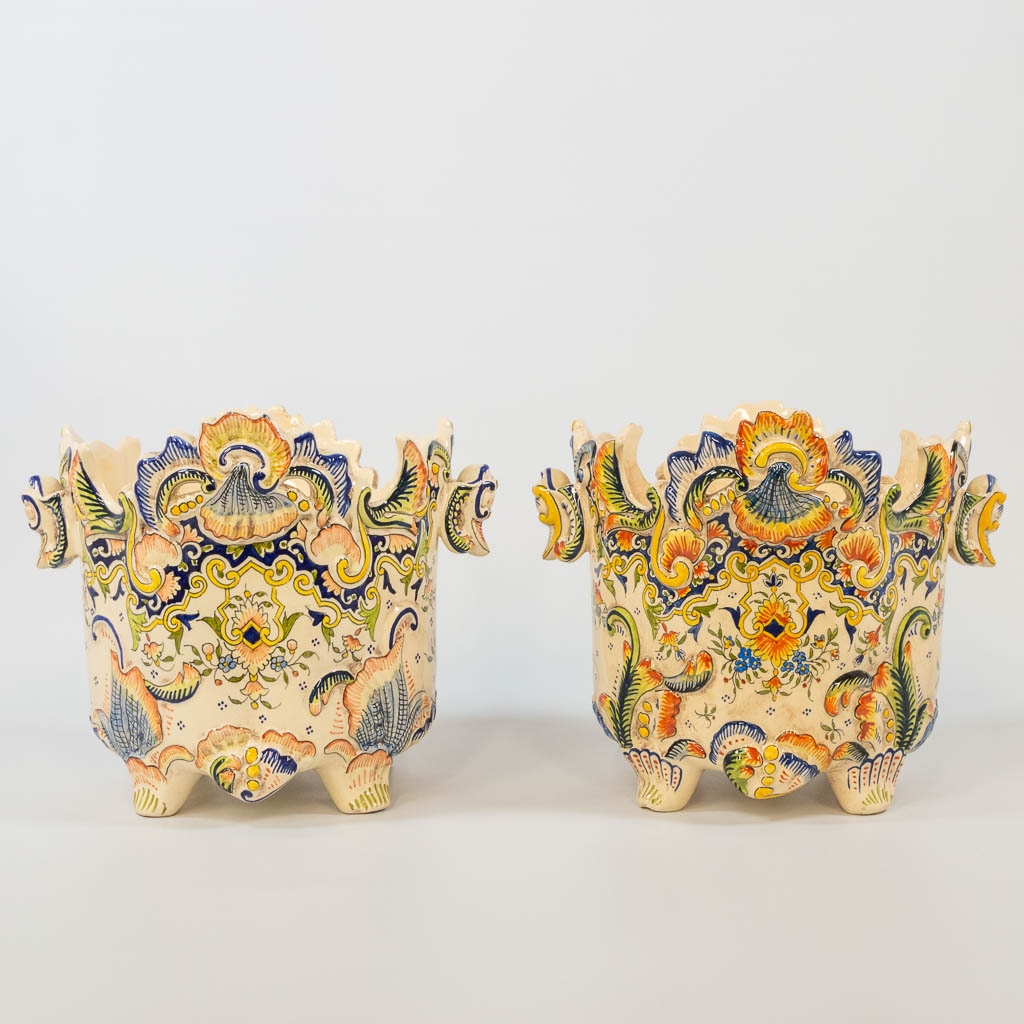 A pair of cache-pots with hand-painted decor, made of faience in Rouen, France. 