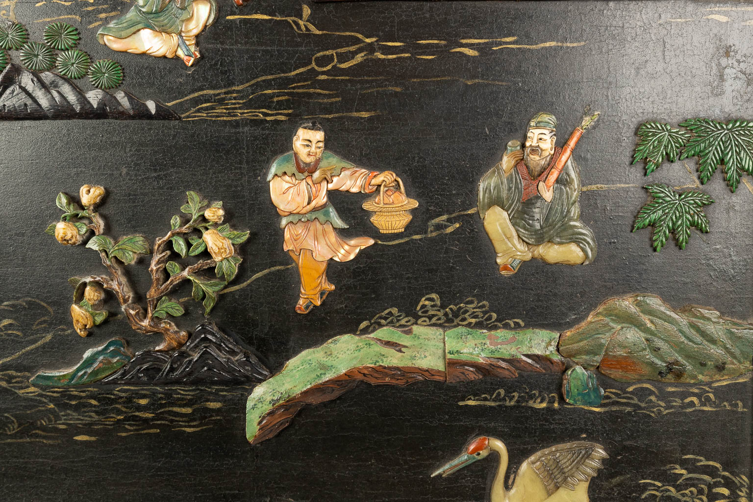 A Chinese sculptured table screen with images of the 8 immortals, cranes, deer and pine trees. (H:80cm)