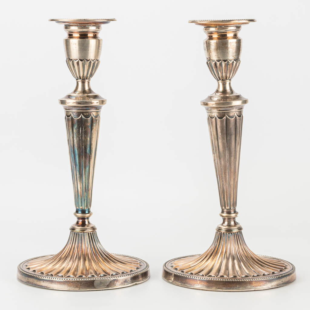 A pair of silver candlesticks marked DJS, D J Silver Repairs, 1966. 