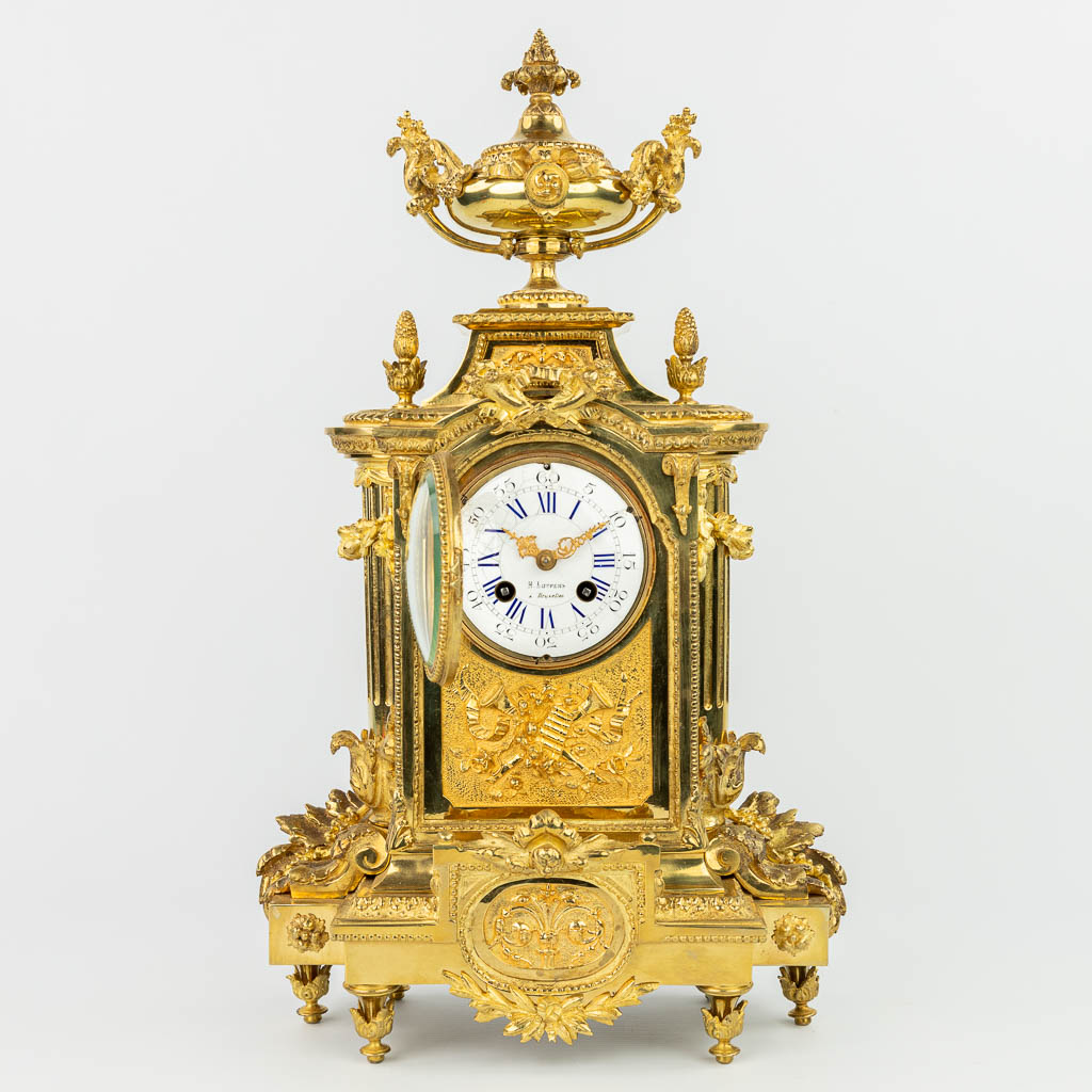 A mantle clock made of gilt bronze and marked Luppens. (H:48cm)