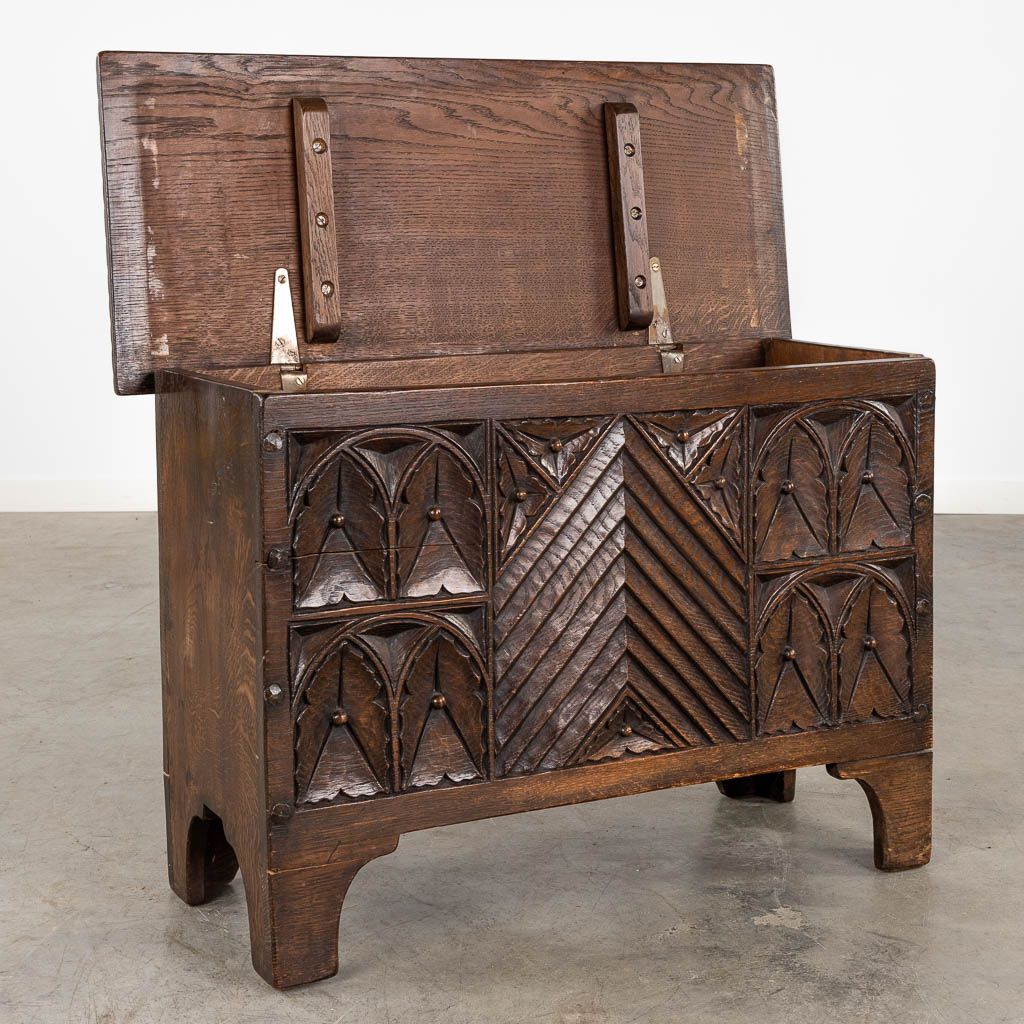 A chest, sculptured panels in a Gothic-revival inspired style. 20th C. (D:35 x W:82 x H:55 cm)