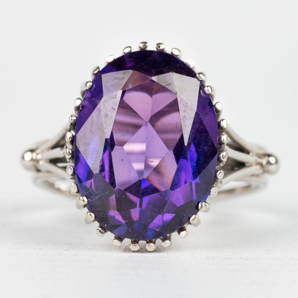 A ring with purple natural stone, made of 18 karat white gold. 