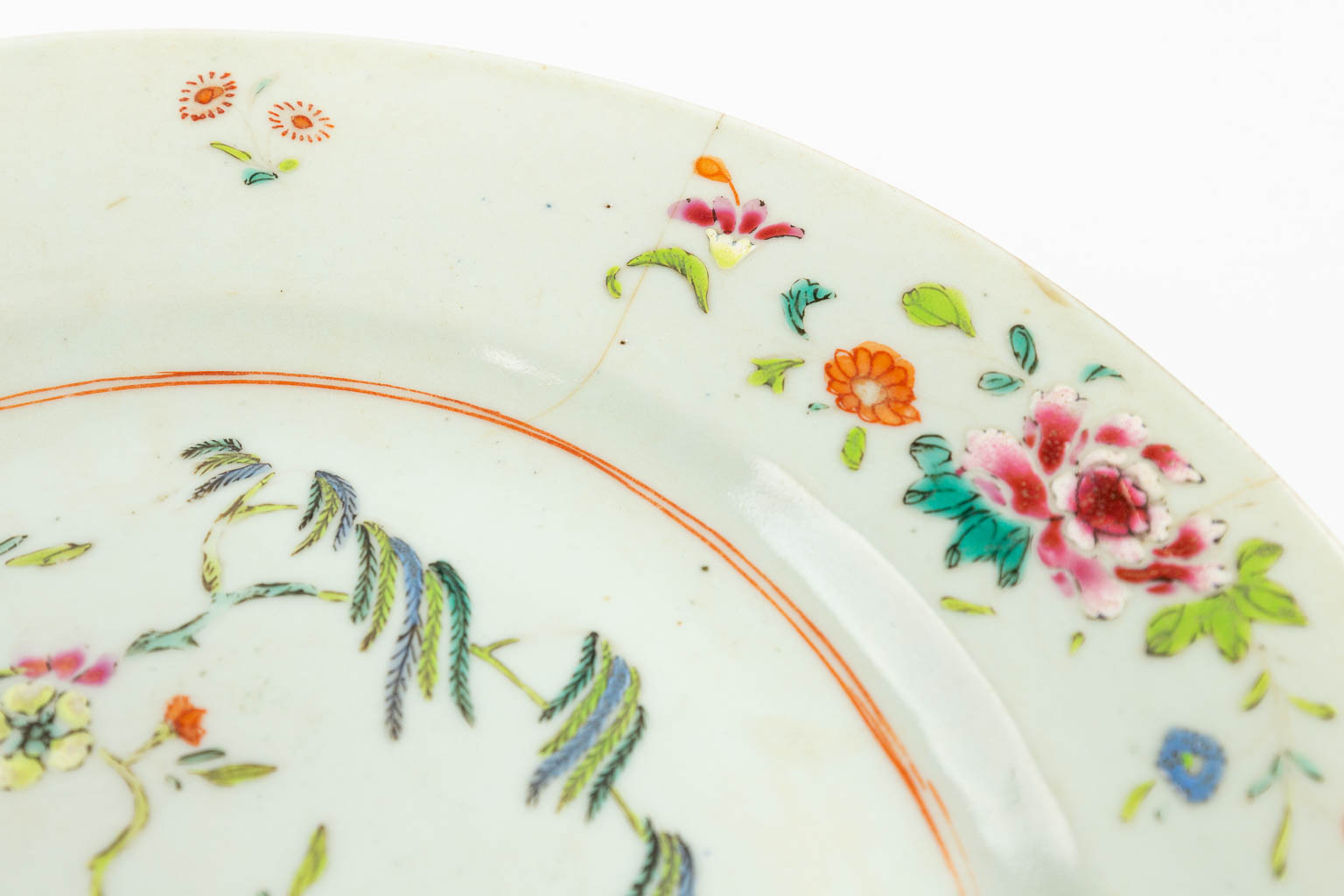 A collection of 7 Chinese Famille Rose plates with hand-painted flower decors. 