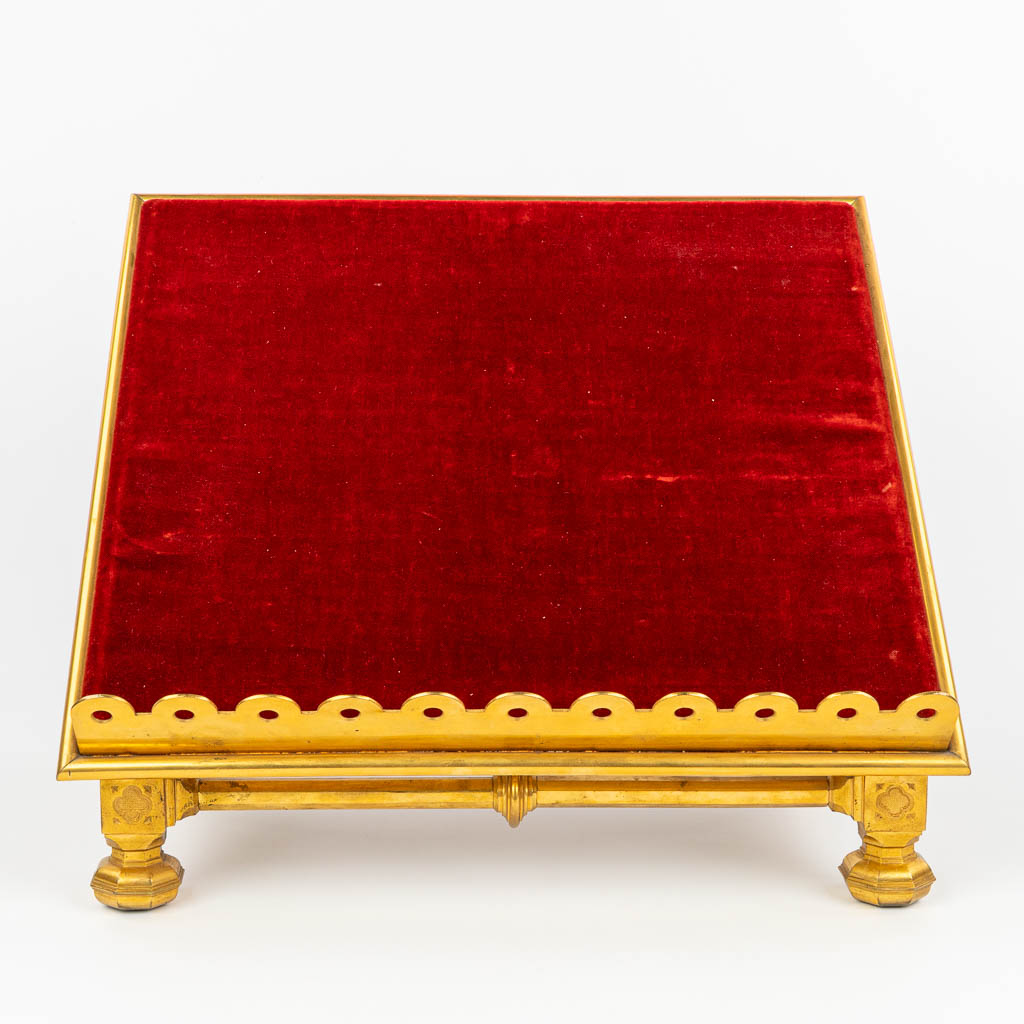 A stand for a Missale Romanum made of gilt bronze in neogothic style and finished with red fabric. (H:35cm)