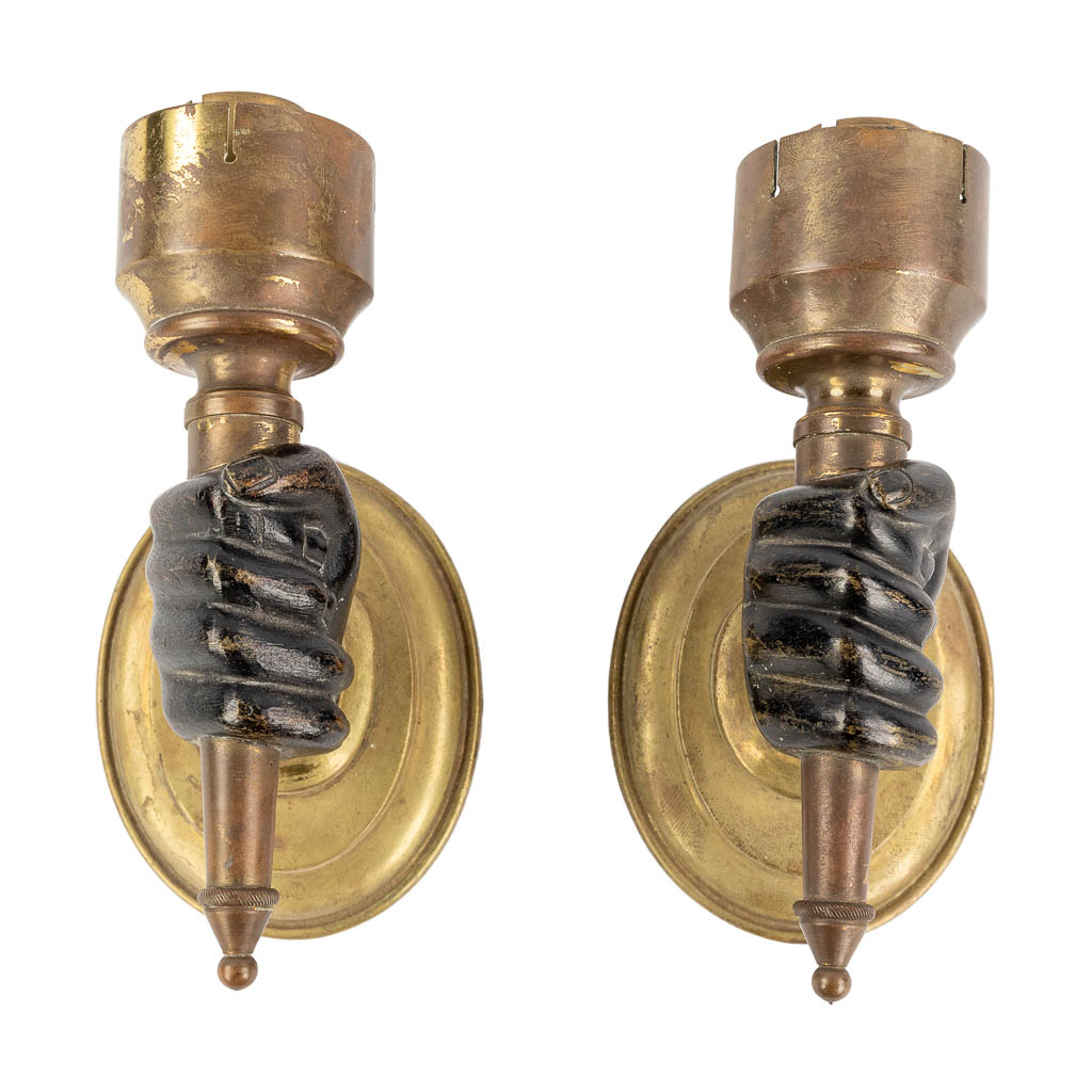 A pair of wall lamps in the shape of a hand with torch, circa 1900.  (L:8 x W:7,5 x H:15 cm)