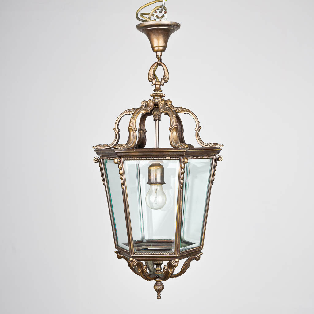 A hall lantern chandelier made of glass and bronze