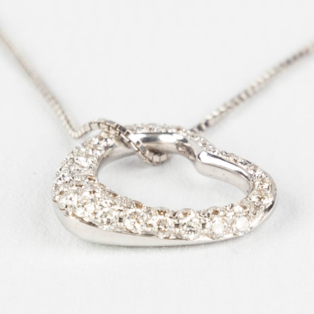 A necklace with a pendant in the shape of a heart. Brilliants, approx. 0.38ct.