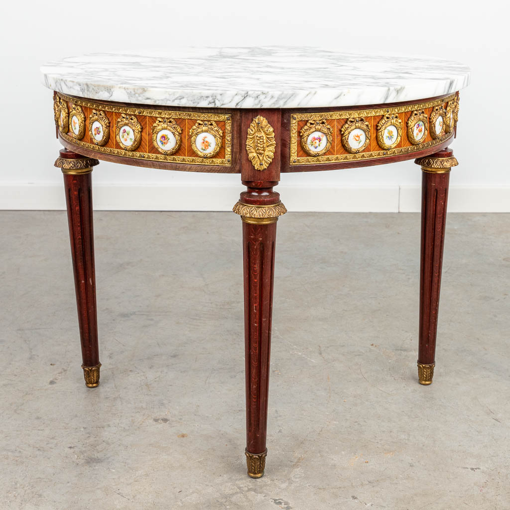 A coffee table with marble top and plaques made of porcelain. (H:49cm)