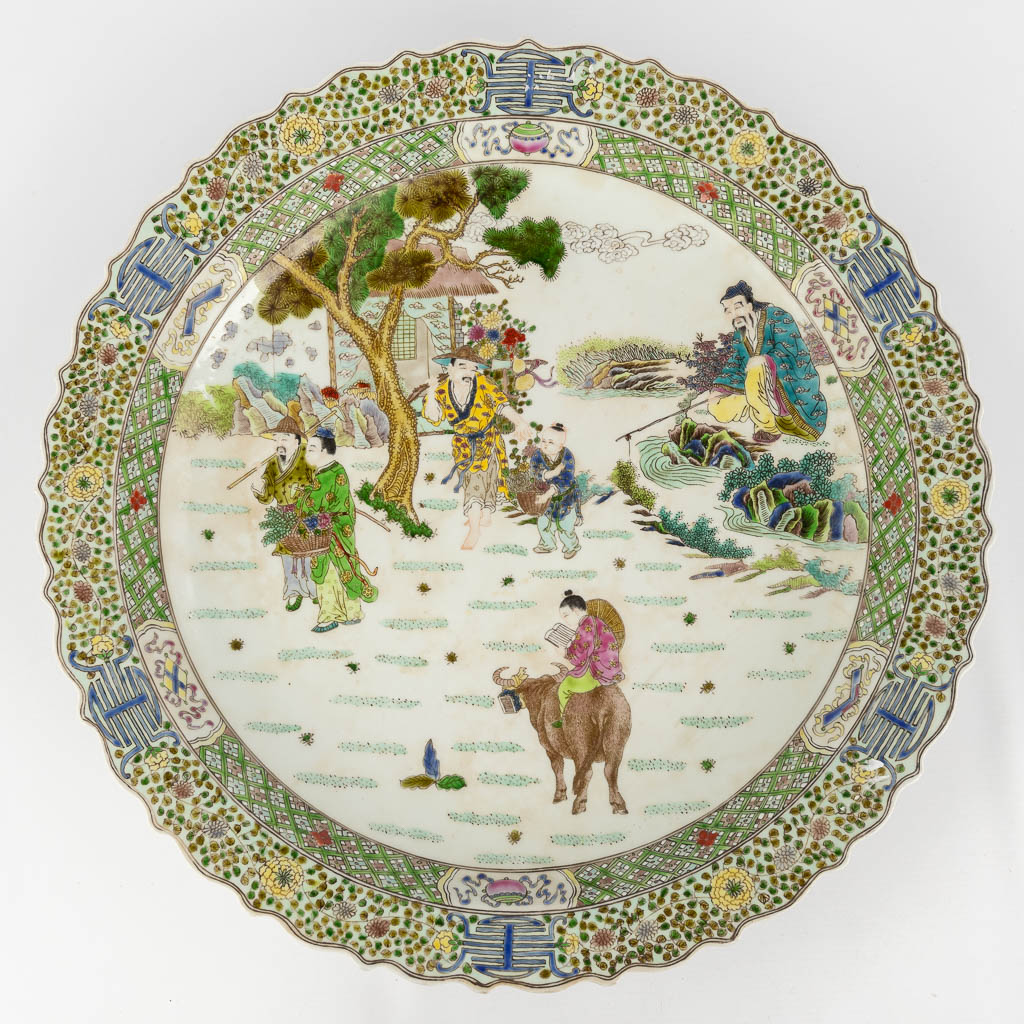  A Chinese plate 'Famille Verte' decorated with Chinese figurines. 20th C. Kangxi mark. 