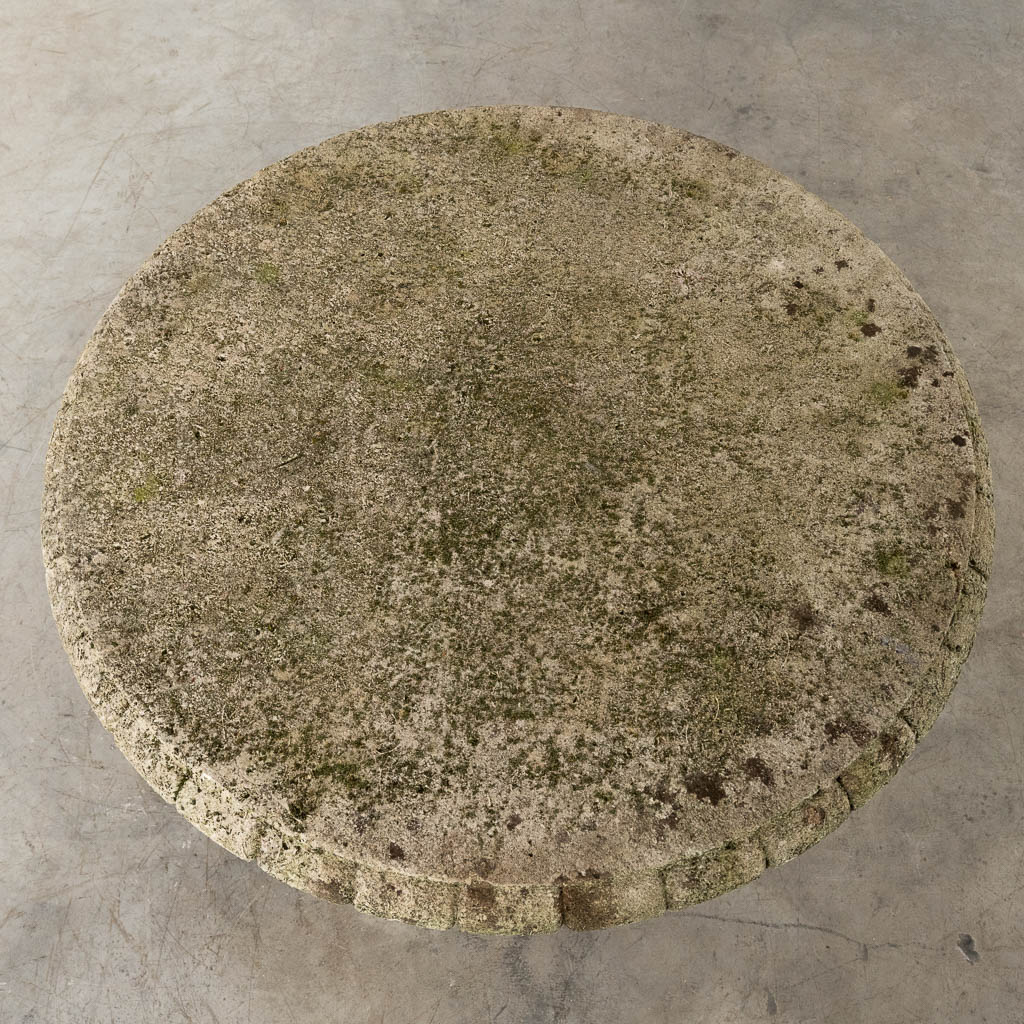 A garden table, concrete decorated with fish. 20th C. (H:65 x D:91 cm)