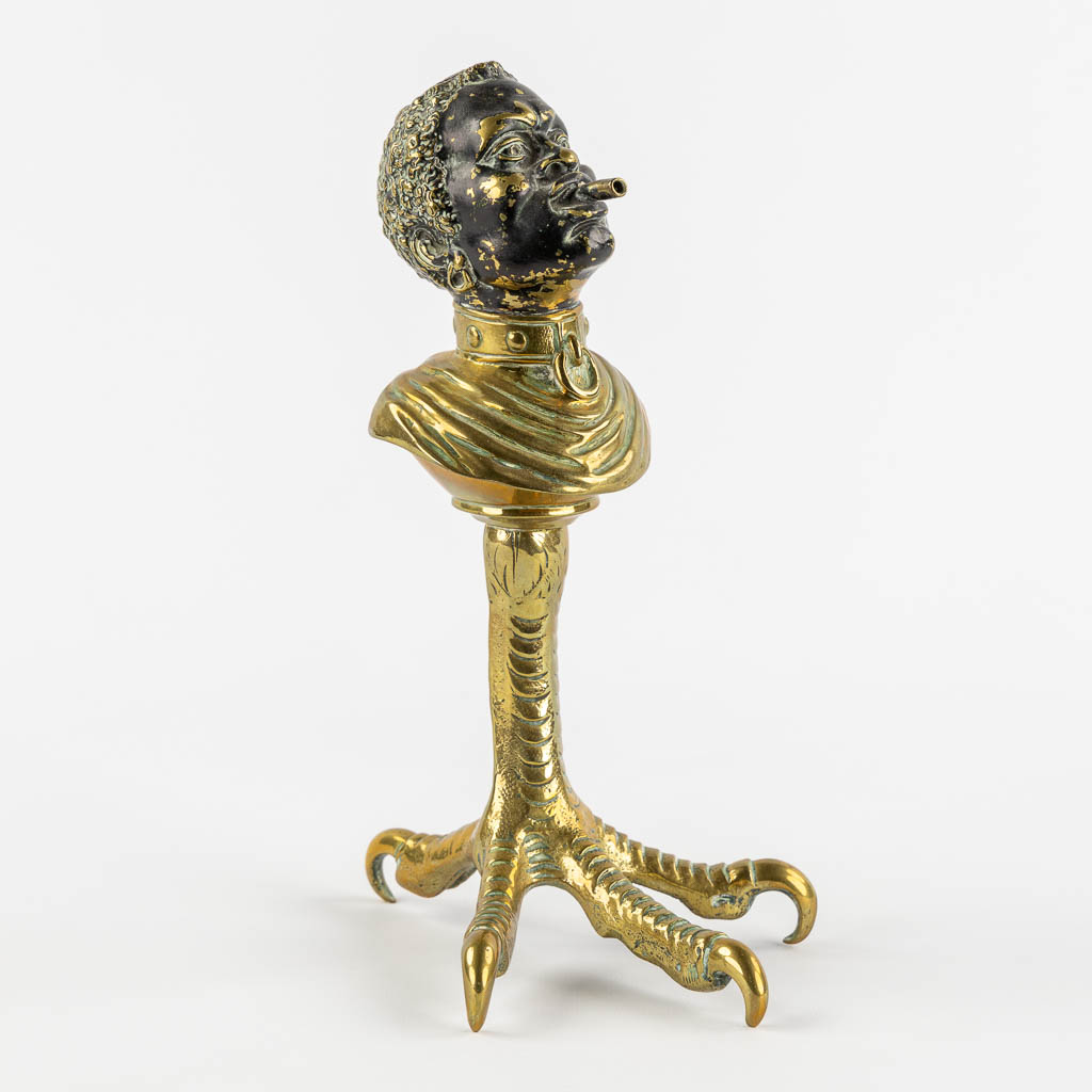  An antique Cigarette or Cigar lighter, polished bronze in the shape of a Blackamoor. 19th/20th C.