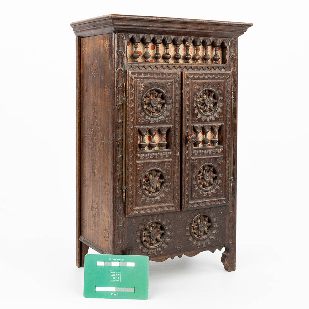 A miniature Breton cabinet, made of sculptured wood. (H:37cm)