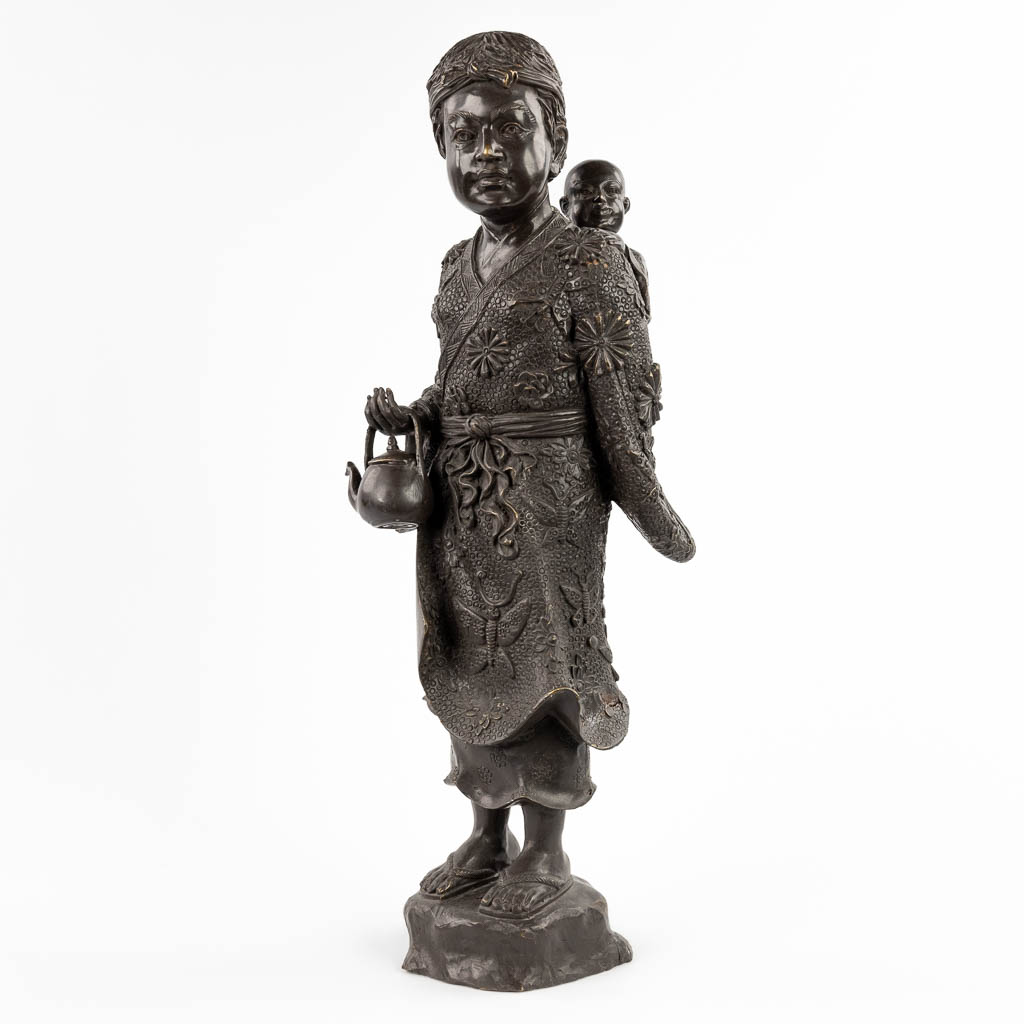 Een Japanse Okimono van een Moeder met kind, gepatineerd brons. 20ste eeuw. (D:18 x W:22 x H:59 cm)
