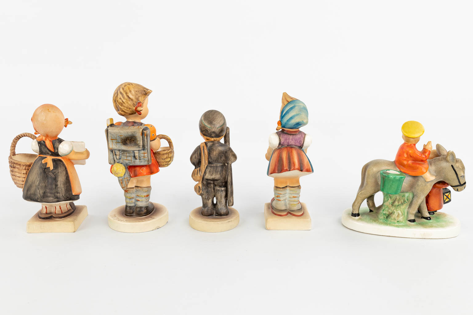 A collection of 9 statues made by Goebel of which 8 are marked Hummel. (H:13cm)