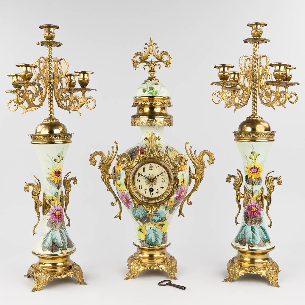  Een driedelige schouwgarnituur met klok en kandelaars, circa 1900
