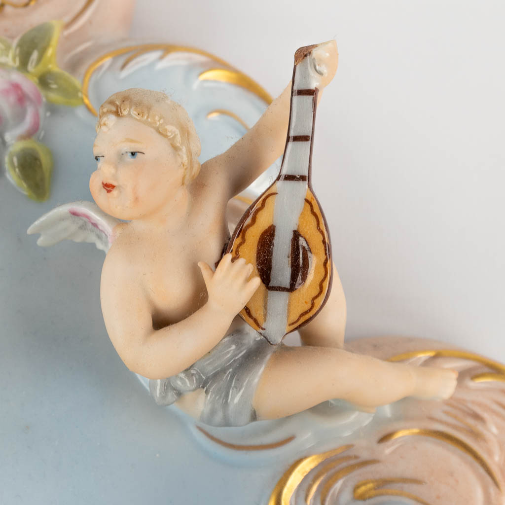 Dresden Porcelain, a pair of decorative wall plaques, decorated with musical putti. 20th C. (W:27 x H:33 cm)
