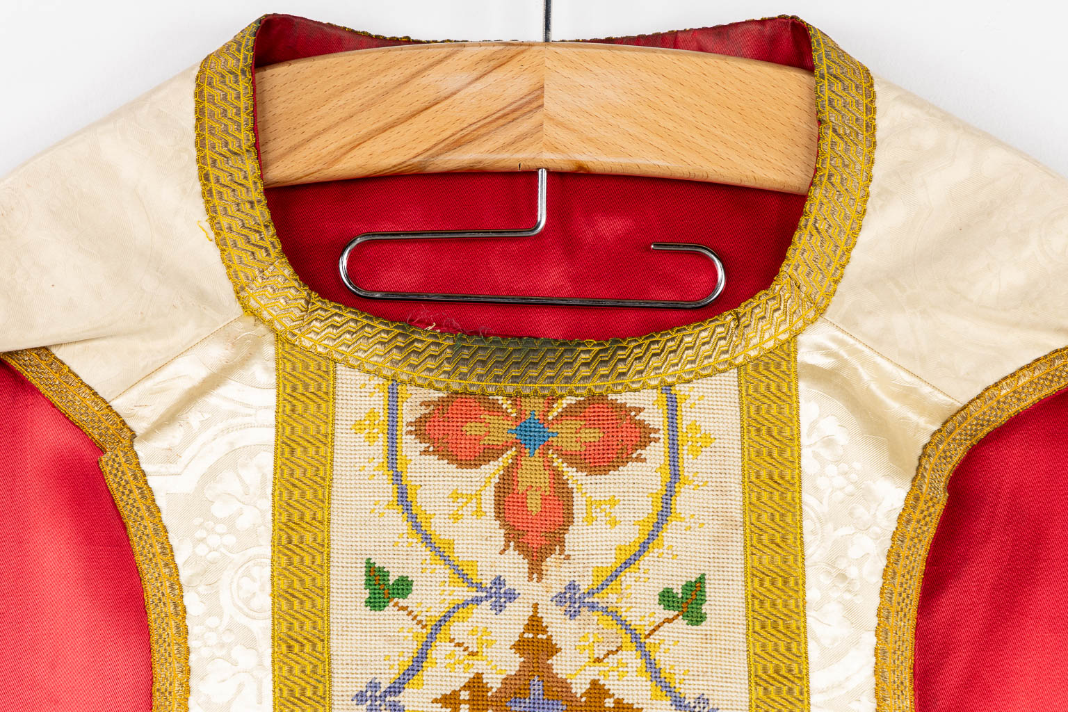 A Humeral Veil and Four Roman Chasubles, embroideries with an IHS and floral decor. 