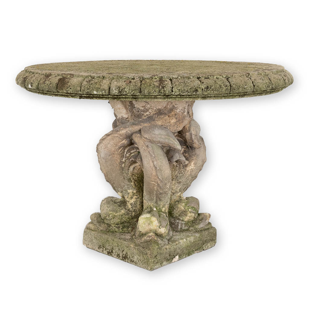 A garden table, concrete decorated with fish. 20th C. (H:65 x D:91 cm)