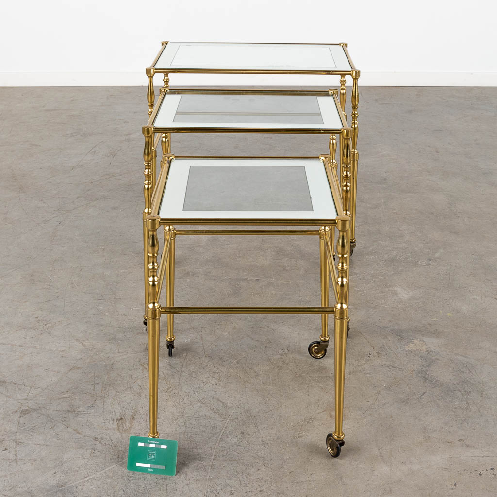 A set of nesting tables, brass and glass. 20th C. (D:39 x W:56 x H:52 cm)