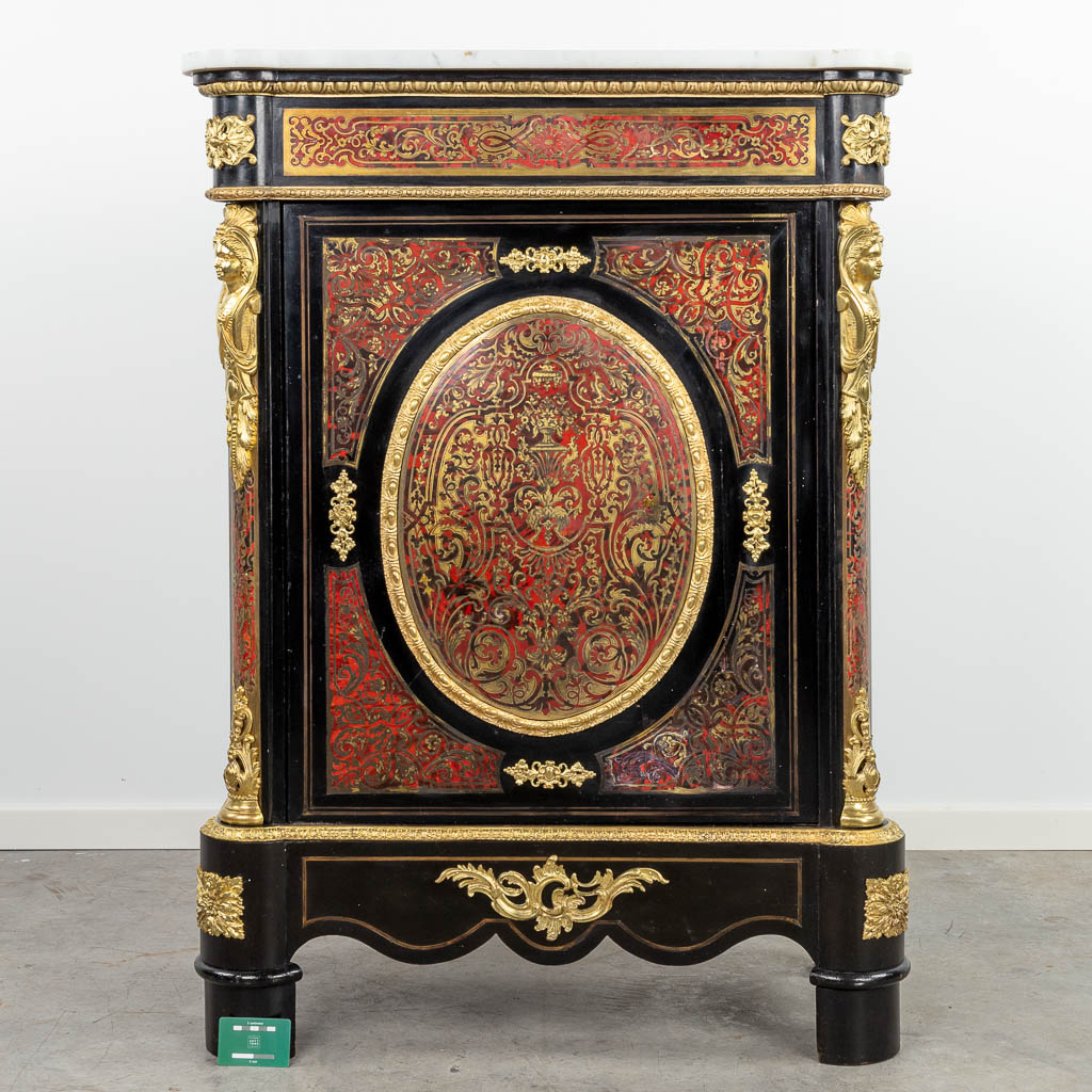 A single door cabinet finished with boulle tortoise shell inlay and mounted with gilt bronze. Napoleon 3. 