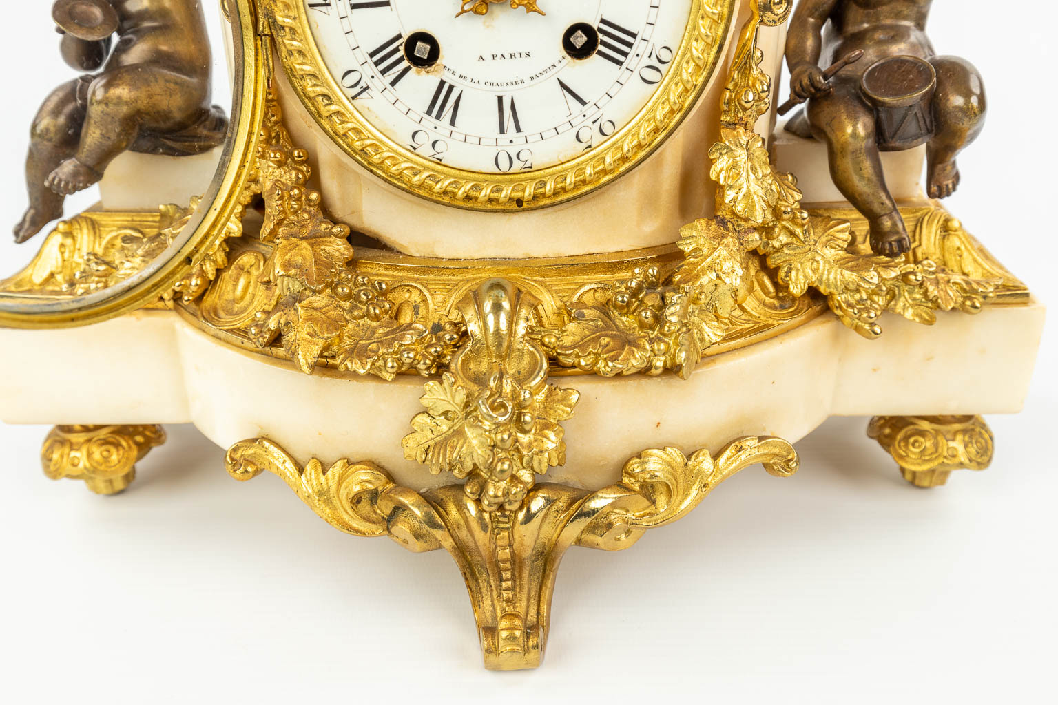 A clock made of marble and decorated with gilt and patinated bronze in Louis XVI style. (H:42cm)