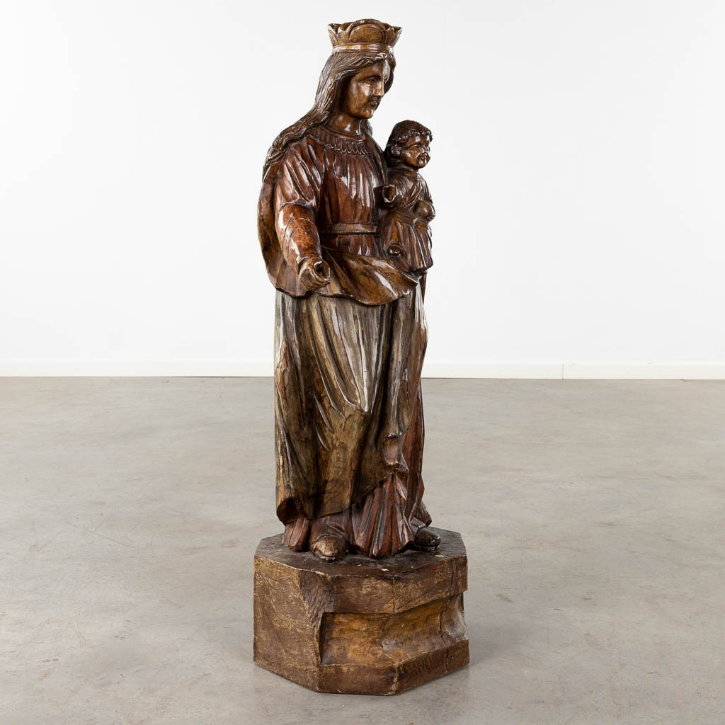 A large wood-sculptured figurine of Madonna. (D:28 x W:29 x H:95 cm)