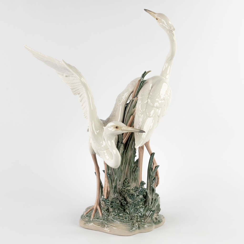 Lladro, 'Two Herons' glazed porcelain. 20th C. (D:36 x W:40 x H:57 cm)
