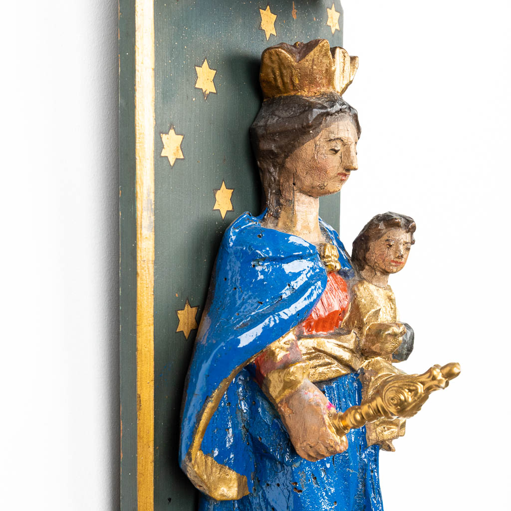 A statue of Madonna with child mounted in a young stand. (H:62,5cm)